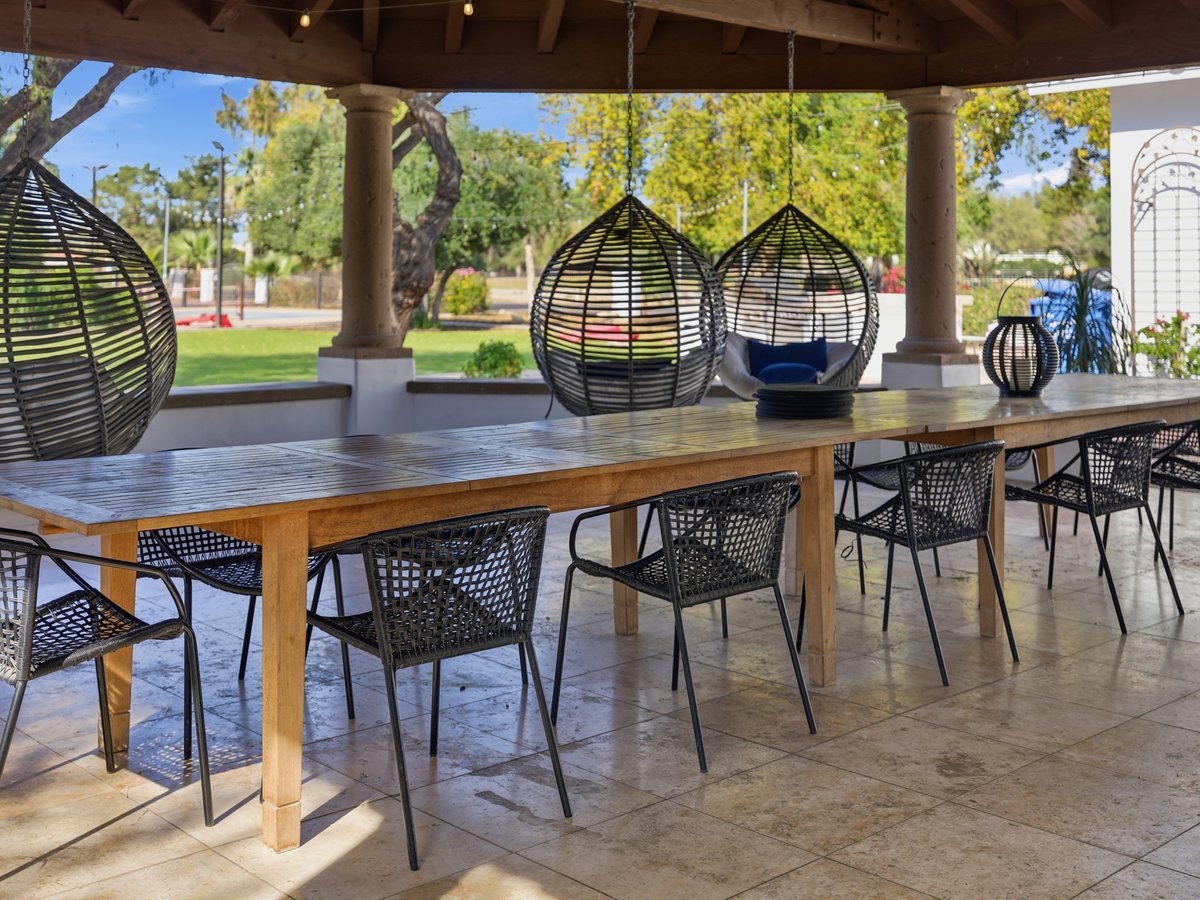 Covered patio with communal dining table at a managed short-term rental in Scottsdale