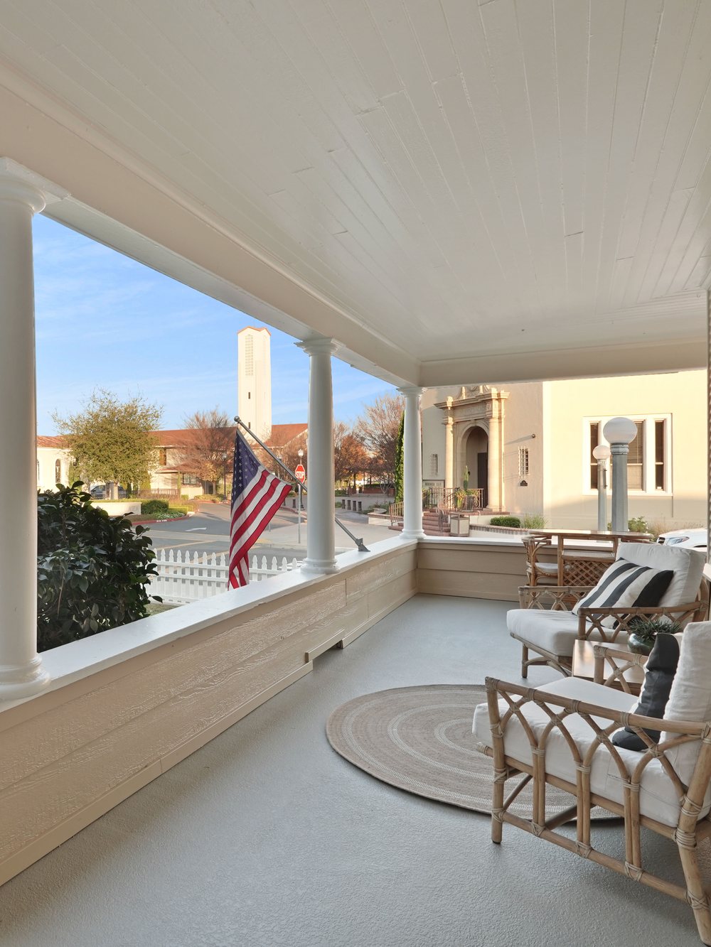Sunlit wraparound porch of a managed short-term rental in Lodi, California